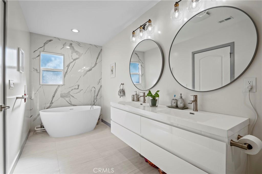 4704 Briggs Avenue La Crescenta, CA 91214 - Photo 4 of 28 a bathroom with a sink mirror and tub