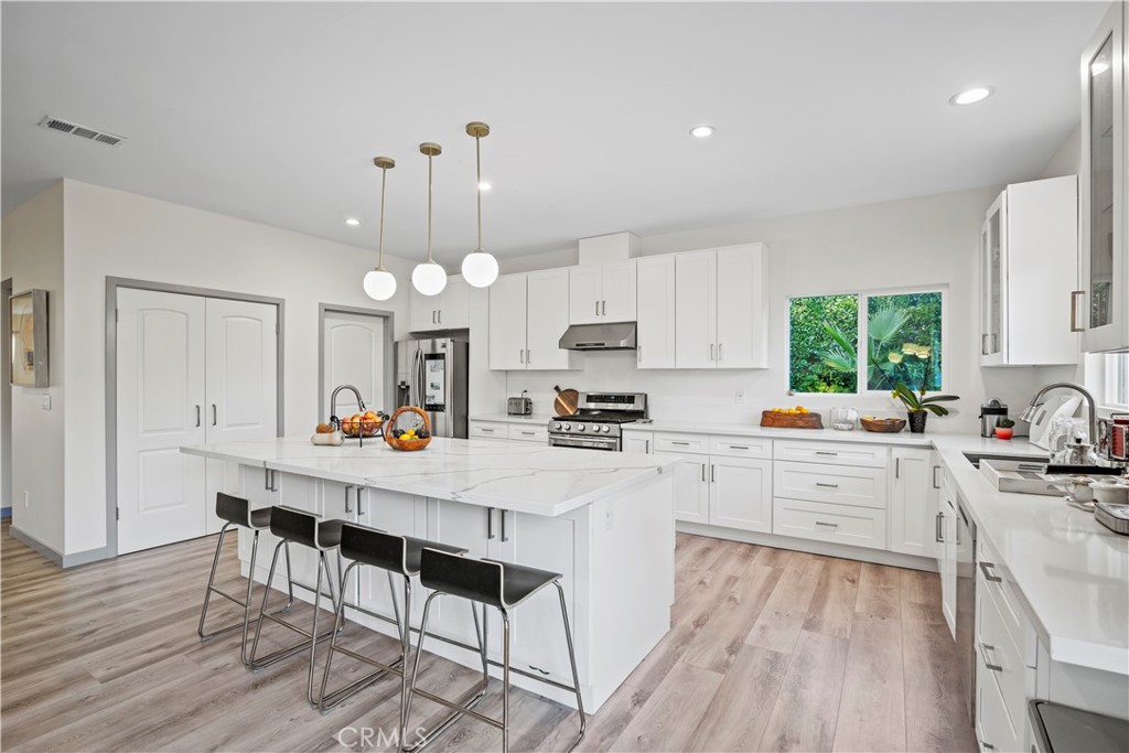 4704 Briggs Avenue La Crescenta, CA 91214 - Photo 7 of 28 a kitchen with a dining table chairs sink and cabinets