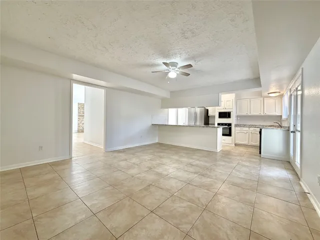 a view of a kitchen with furniture and an empty room