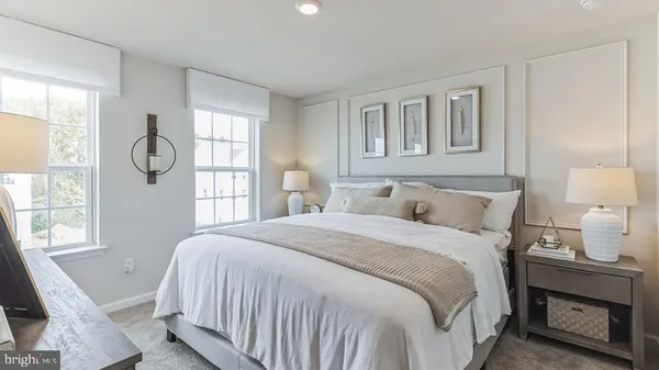 a bedroom with a bed a mirror and a window