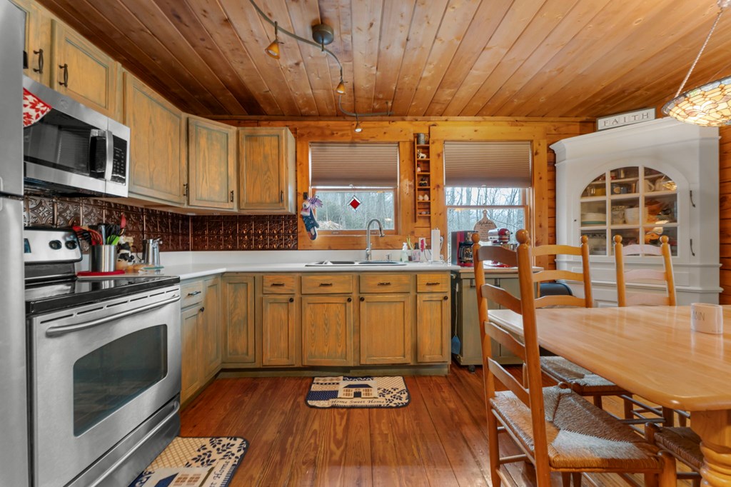 451 Summit Road Otto, NC 28763 - Photo 12 of 40 a kitchen with stainless steel appliances granite countertop a stove a sink dishwasher and a microwave oven with cabinets