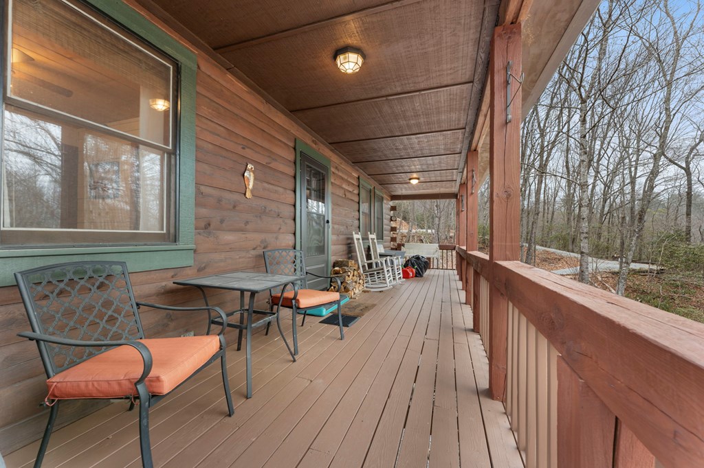 451 Summit Road Otto, NC 28763 - Photo 3 of 40 a balcony with chairs and wooden fence
