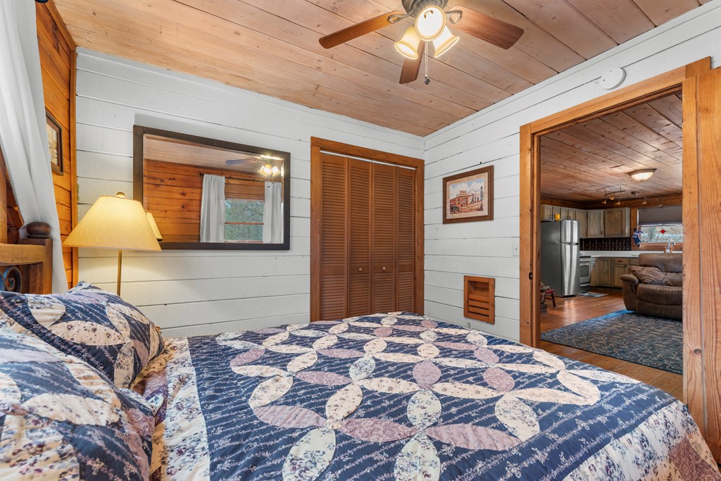 451 Summit Road Otto, NC 28763 - Photo 34 of 40 a bedroom with a bed and a lamp