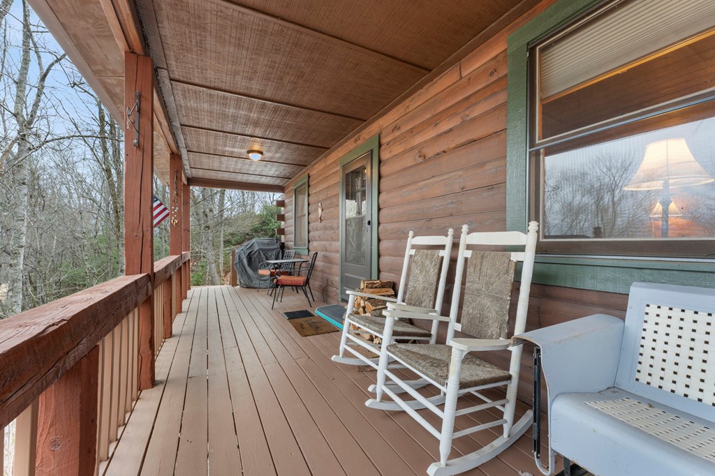 451 Summit Road Otto, NC 28763 - Photo 4 of 40 a view of balcony with wooden floor and outdoor seating