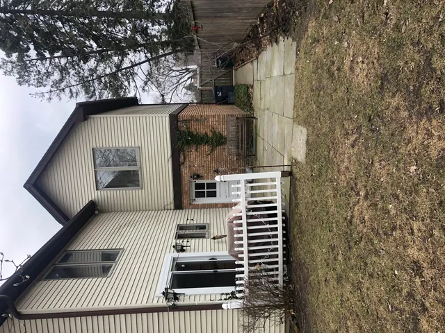 a view of a patio with a table and chairs and potted plants