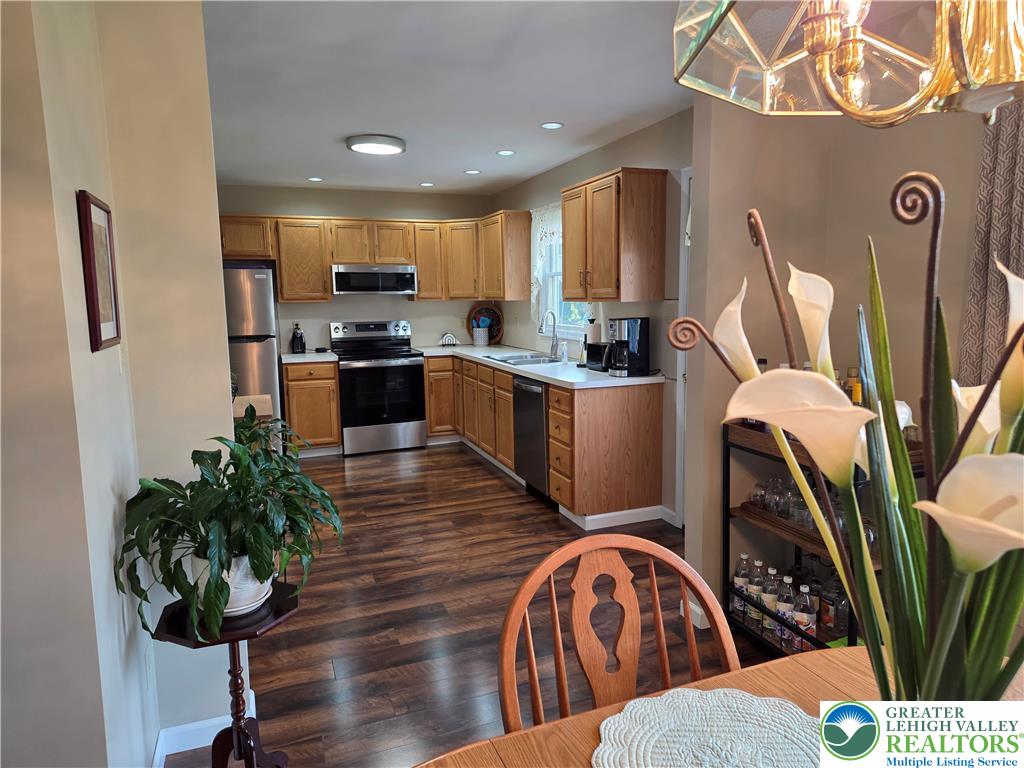 844 Catherine Drive Coplay, PA 18037 - Photo 32 of 52 a kitchen with stainless steel appliances kitchen island granite countertop a refrigerator a stove a sink dishwasher and wooden floor