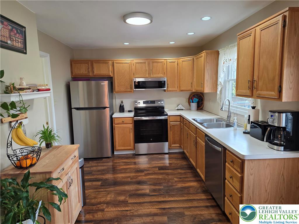 844 Catherine Drive Coplay, PA 18037 - Photo 33 of 52 a kitchen with kitchen island a counter top space a sink a stove and a refrigerator