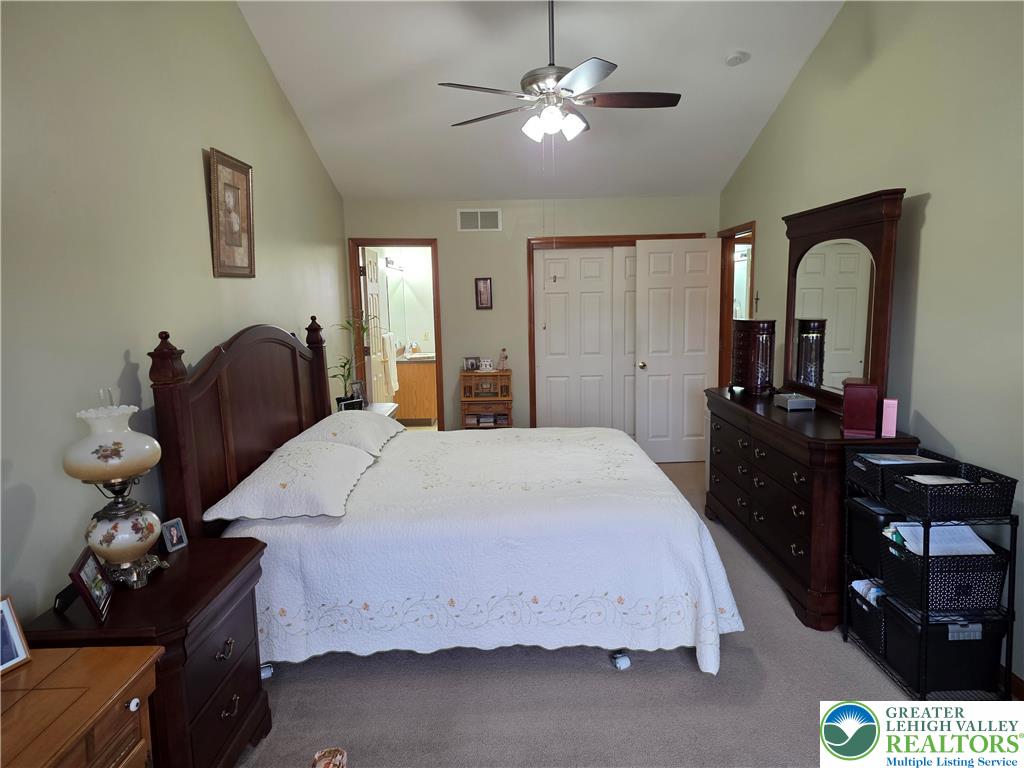 844 Catherine Drive Coplay, PA 18037 - Photo 46 of 52 a bedroom with a bed dresser and a chandelier