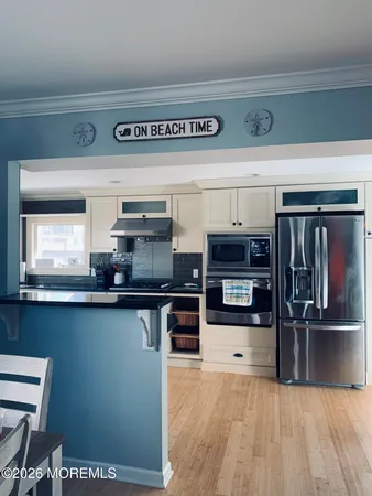 a kitchen with stainless steel appliances granite countertop a stove and a refrigerator