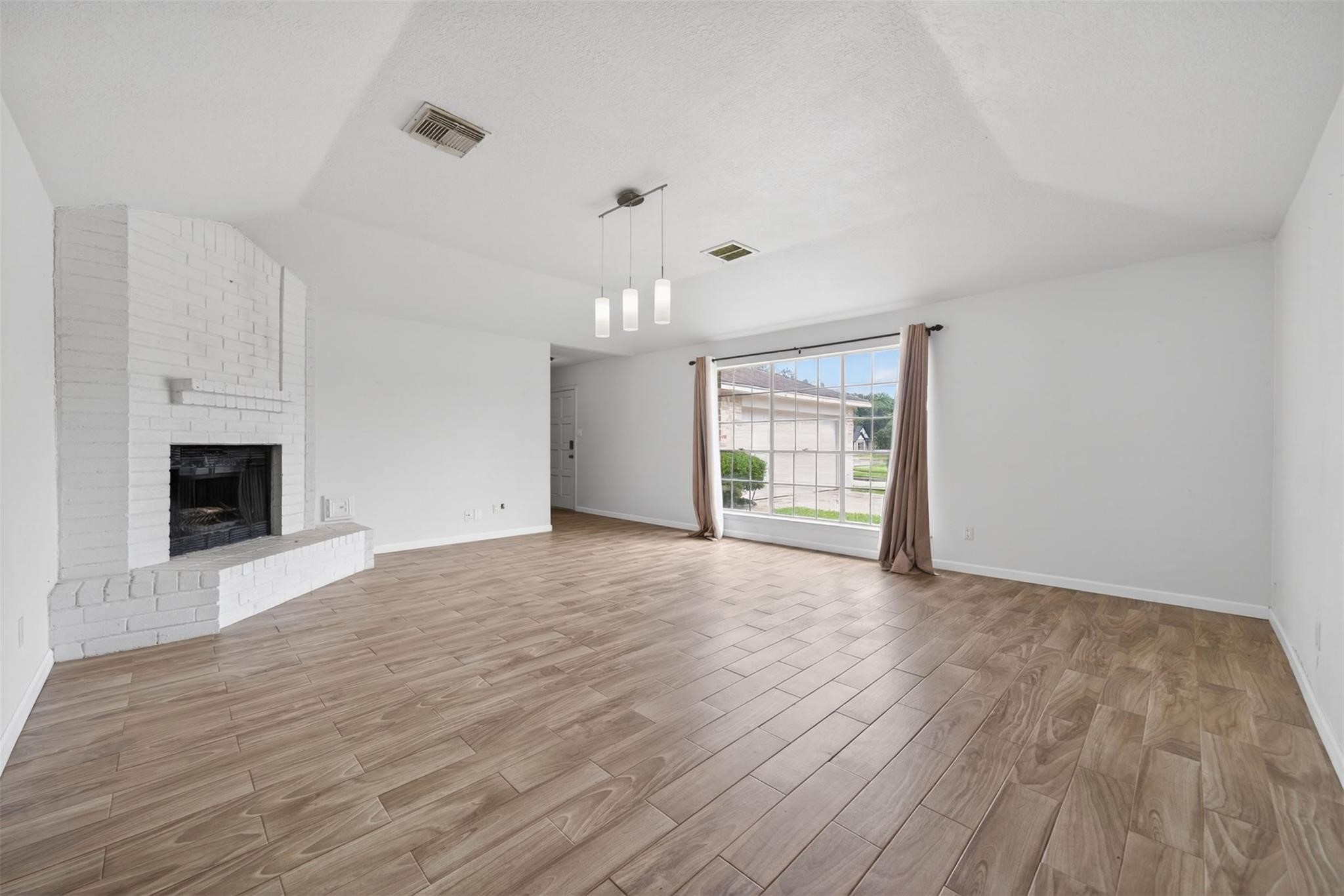 17002 Dew Drop Lane Houston, TX 77095 - Photo 4 of 24 a view of an empty room with a fireplace and a window