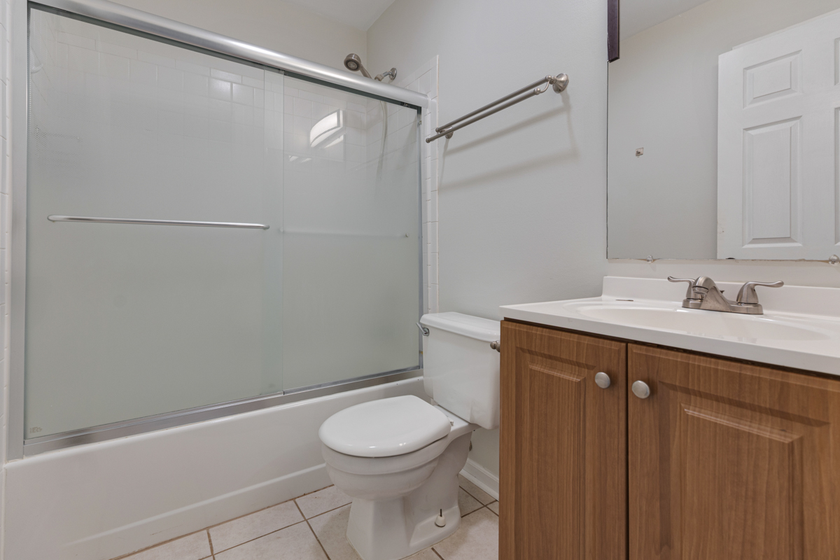 106 Gant Circle, Unit H Streamwood, IL 60107 - Photo 13 of 20 a bathroom with a sink a toilet and shower