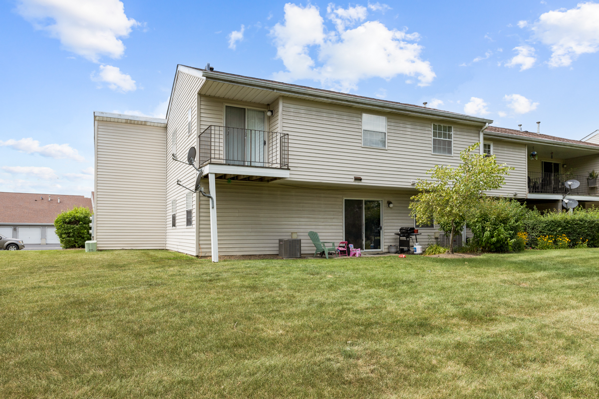 106 Gant Circle, Unit H Streamwood, IL 60107 - Photo 15 of 20 a view of a house with a yard and a large tree