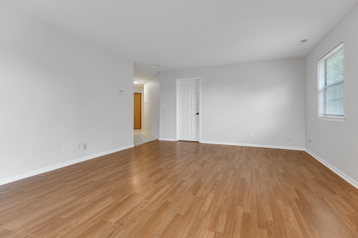 106 Gant Circle, Unit H Streamwood, IL 60107 - Photo 2 of 20 a view of empty room with wooden floor and fan
