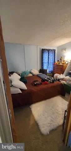 a bed sitting in a room next to a window