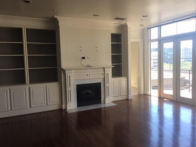 3535 Gillespie Street, Unit 505 Dallas, TX 75219 - Photo 2 of 5 a view of an empty room with wooden floor and a window