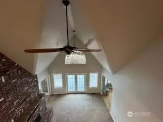 a view of a livingroom with a ceiling fan and window
