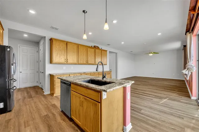 a kitchen that has a sink and a stove in it