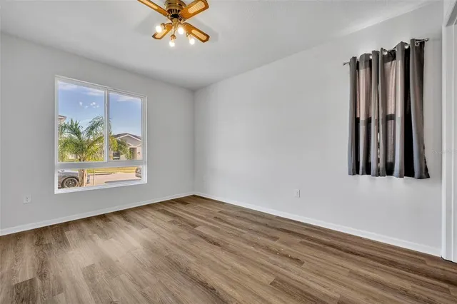 wooden floor in an empty room with a window