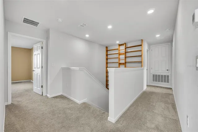 wooden floor in an empty room with a bathroom