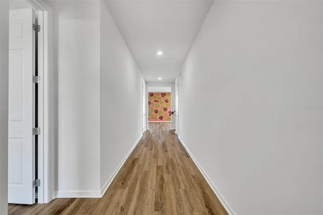 a view of hallway with wooden floor