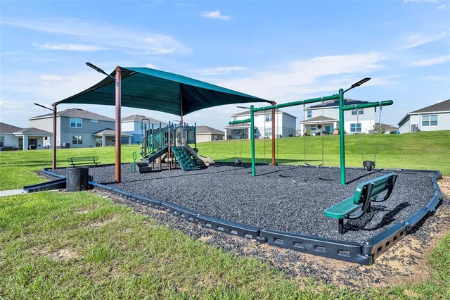 a view of a house with backyard and porch