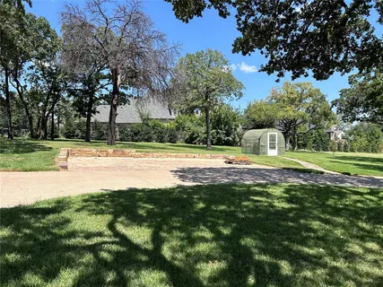 a view of outdoor space with swimming pool and green space