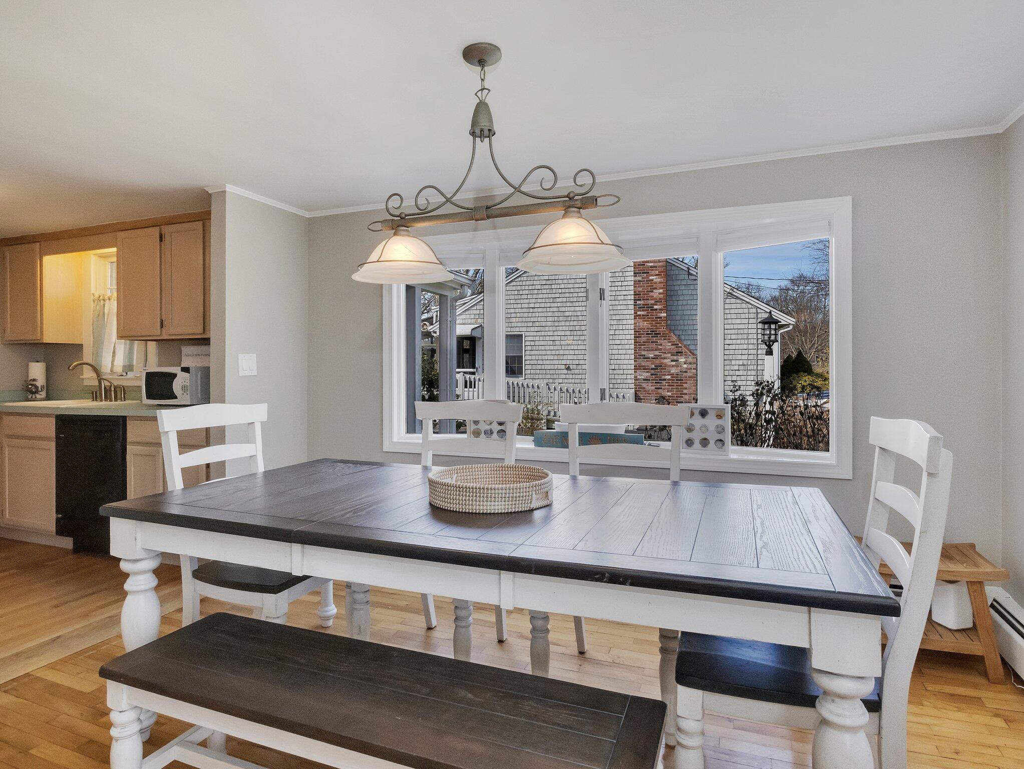41 Harbor Road West Yarmouth, MA 02673 - Photo 12 of 56 a kitchen with a table chairs stove and wooden floor