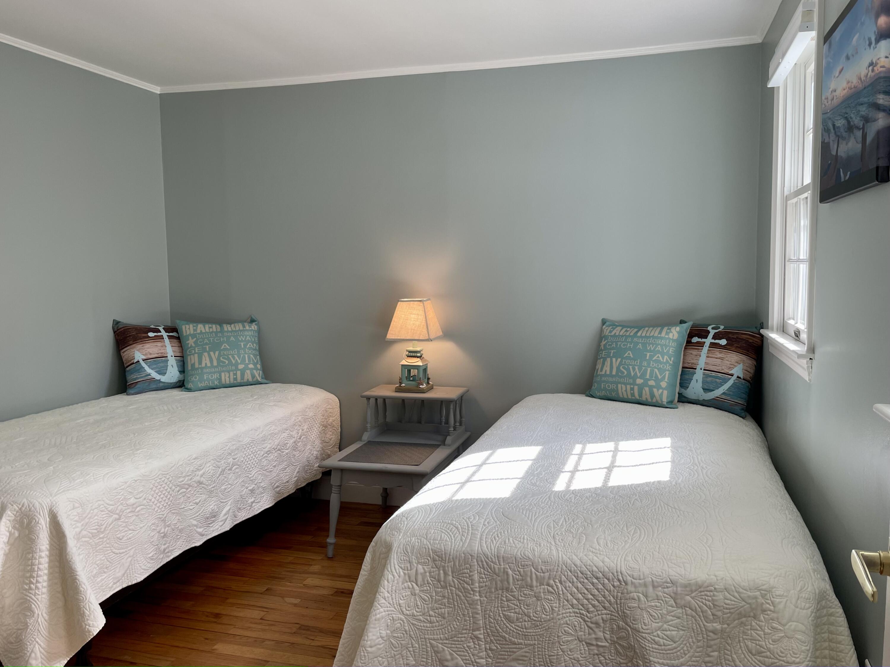 41 Harbor Road West Yarmouth, MA 02673 - Photo 31 of 56 a bedroom with two beds and wooden floor