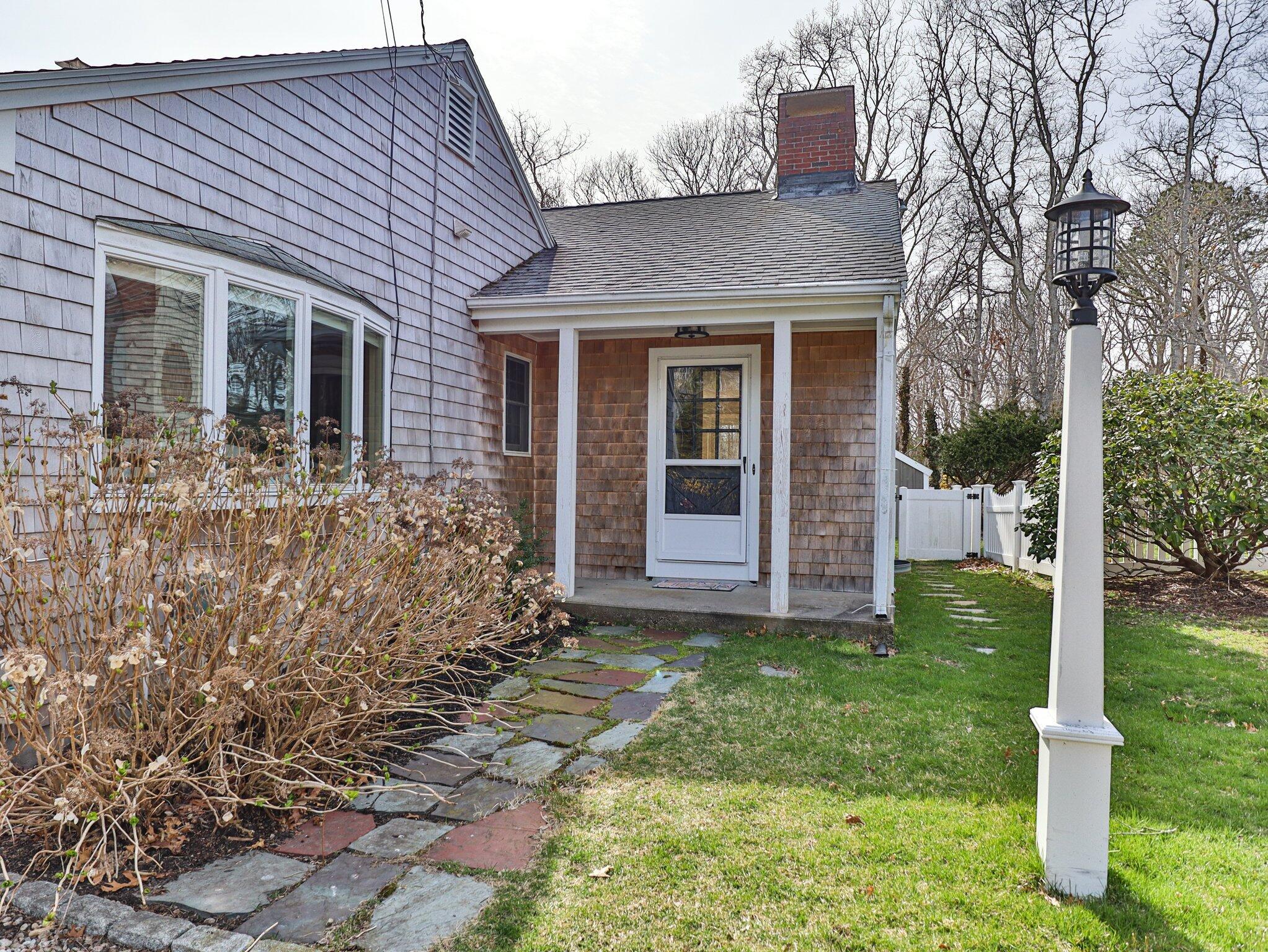 41 Harbor Road West Yarmouth, MA 02673 - Photo 47 of 56 a view of a house with brick walls and a yard with trees