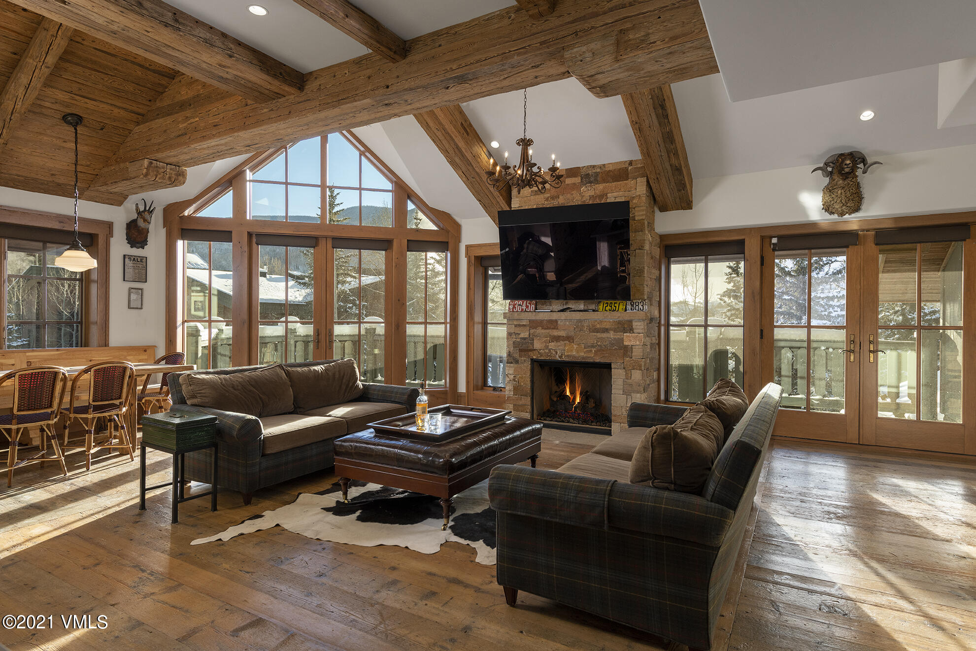 a living room with furniture a fireplace and a floor to ceiling window
