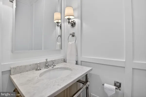 a bathroom with a granite countertop sink a toilet and shower