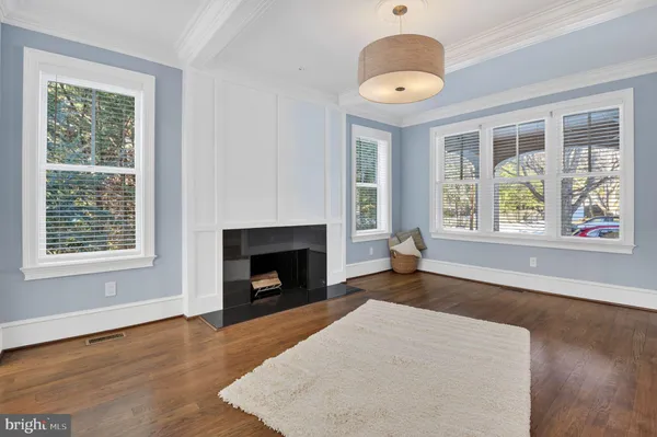 a living room with a fireplace and a window