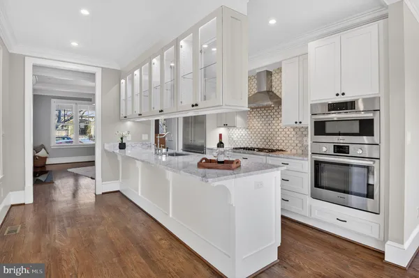 a kitchen with stainless steel appliances a stove top oven and cabinets