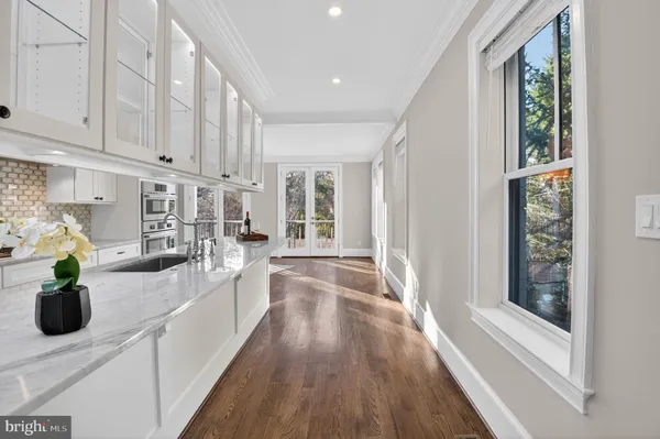 a kitchen with counter top space and wooden floor