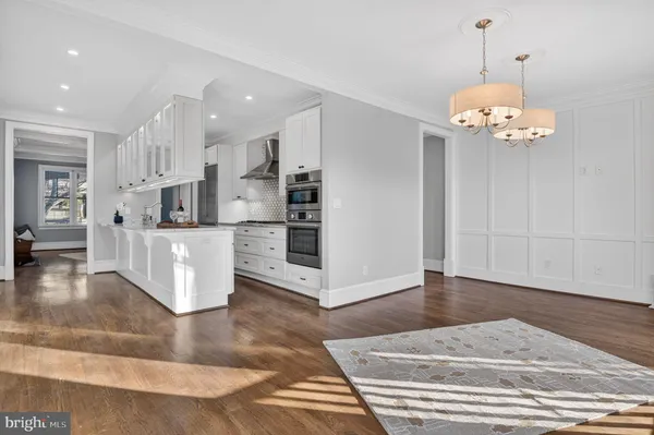 a living room with kitchen island granite countertop furniture and a chandelier