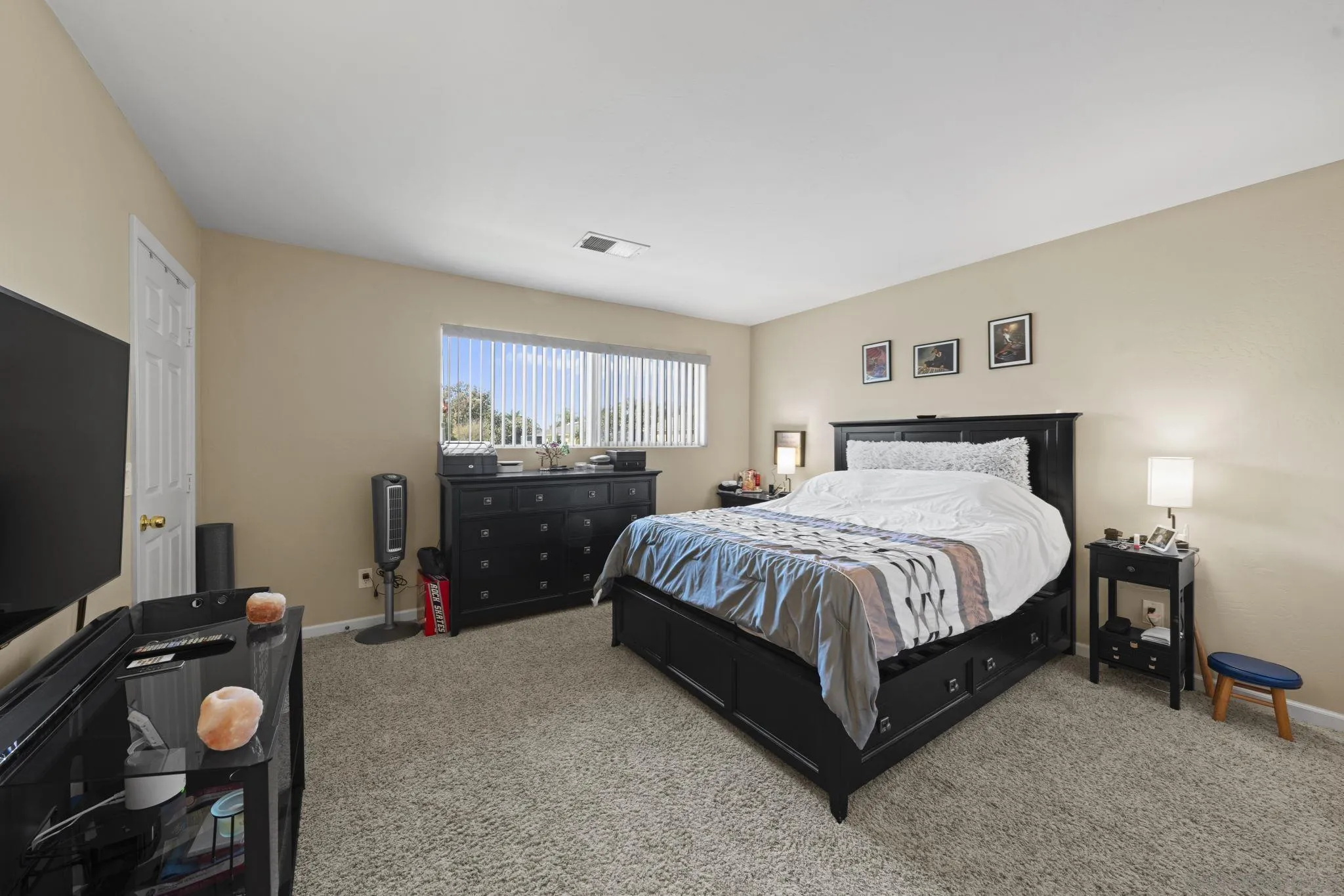 910 North Fig Street, Unit D Escondido, CA 92026 - Photo 12 of 23 a spacious bedroom with a bed and flat screen tv