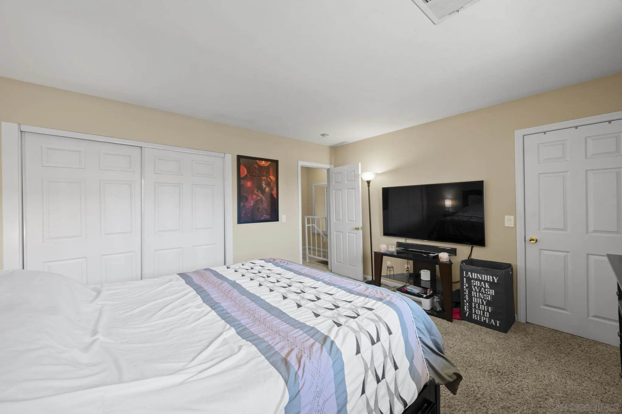 910 North Fig Street, Unit D Escondido, CA 92026 - Photo 13 of 23 a bedroom with a bed and a flat screen tv