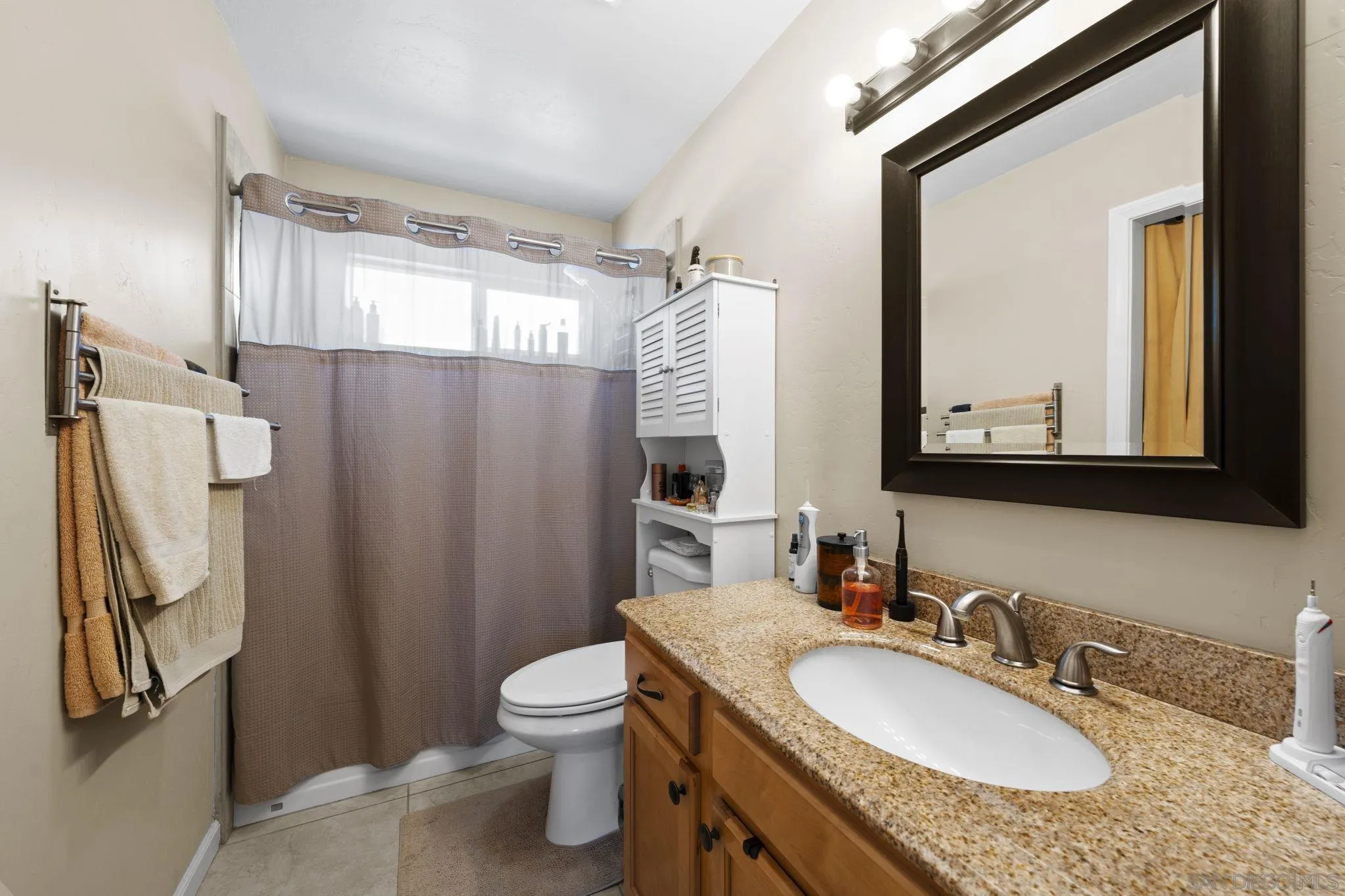 910 North Fig Street, Unit D Escondido, CA 92026 - Photo 16 of 23 a bathroom with a granite countertop sink toilet and shower