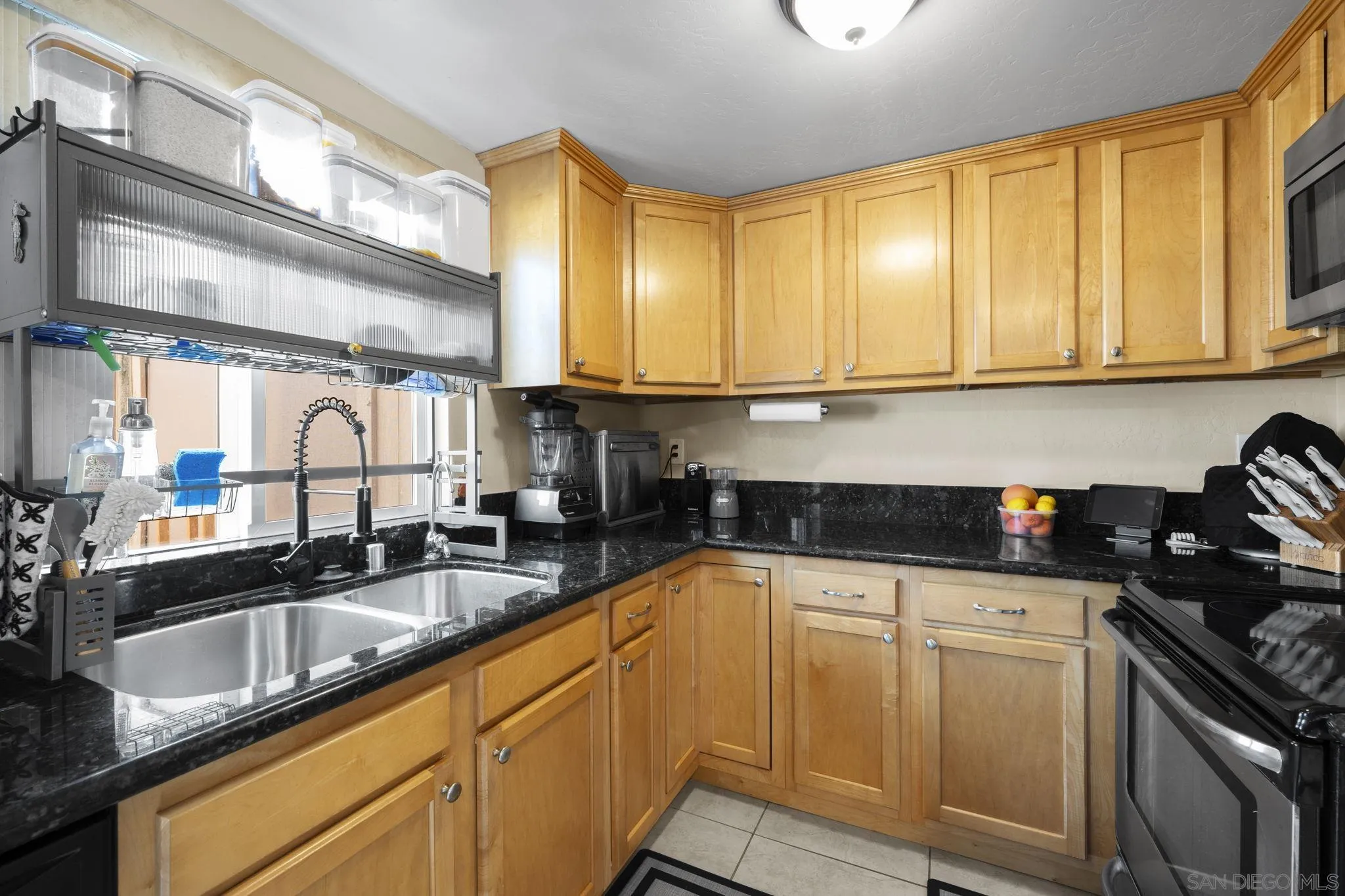910 North Fig Street, Unit D Escondido, CA 92026 - Photo 10 of 23 a kitchen with granite countertop a sink a stove and cabinets