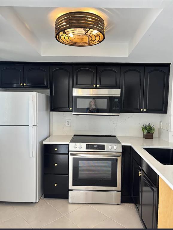 a kitchen with stainless steel appliances granite countertop a stove a microwave and a refrigerator