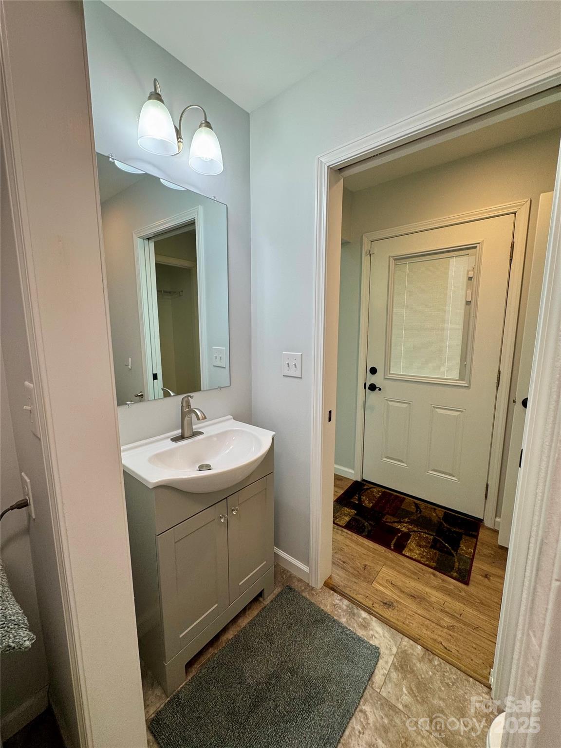 109 Beech Tree Lane Rutherfordton, NC 28139 - Photo 15 of 32 a bathroom with a sink a light fixture and a mirror