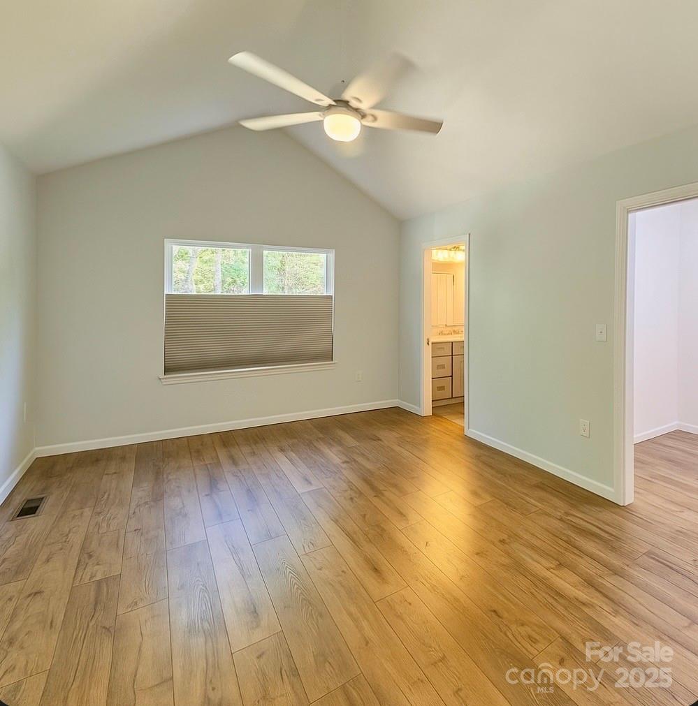 109 Beech Tree Lane Rutherfordton, NC 28139 - Photo 17 of 32 an empty room with wooden floor and windows