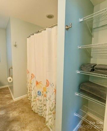 109 Beech Tree Lane Rutherfordton, NC 28139 - Photo 20 of 32 a bathroom with a shower curtain and a sink