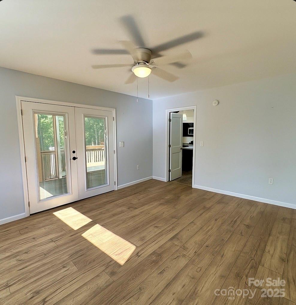 109 Beech Tree Lane Rutherfordton, NC 28139 - Photo 22 of 32 a view of an empty room with wooden floor and a window