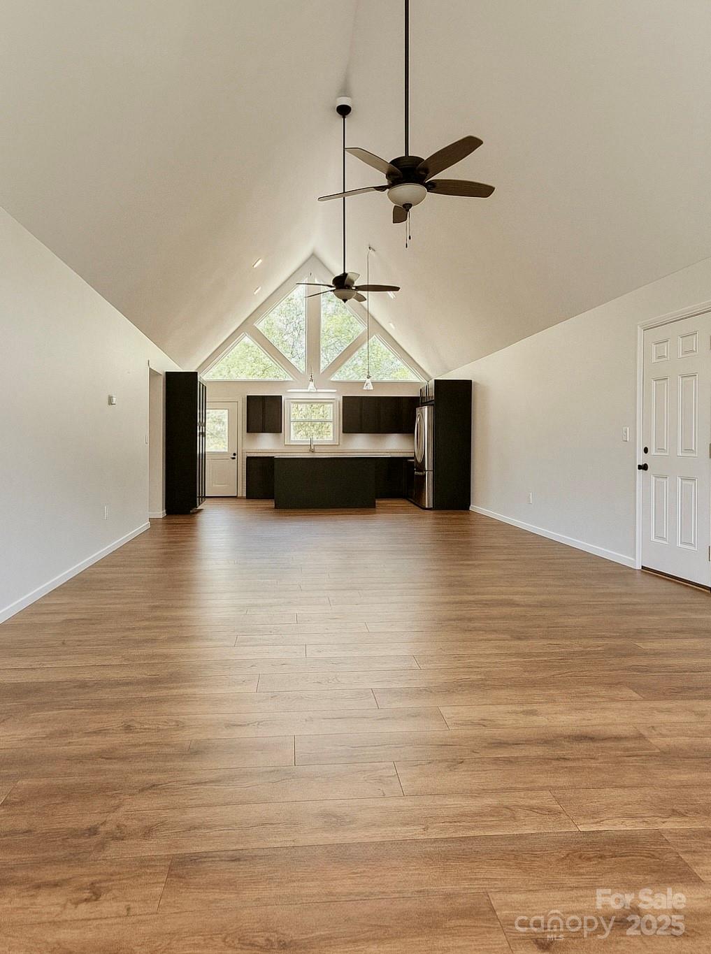 109 Beech Tree Lane Rutherfordton, NC 28139 - Photo 9 of 32 a view of a livingroom with a fireplace a ceiling fan and wooden floor