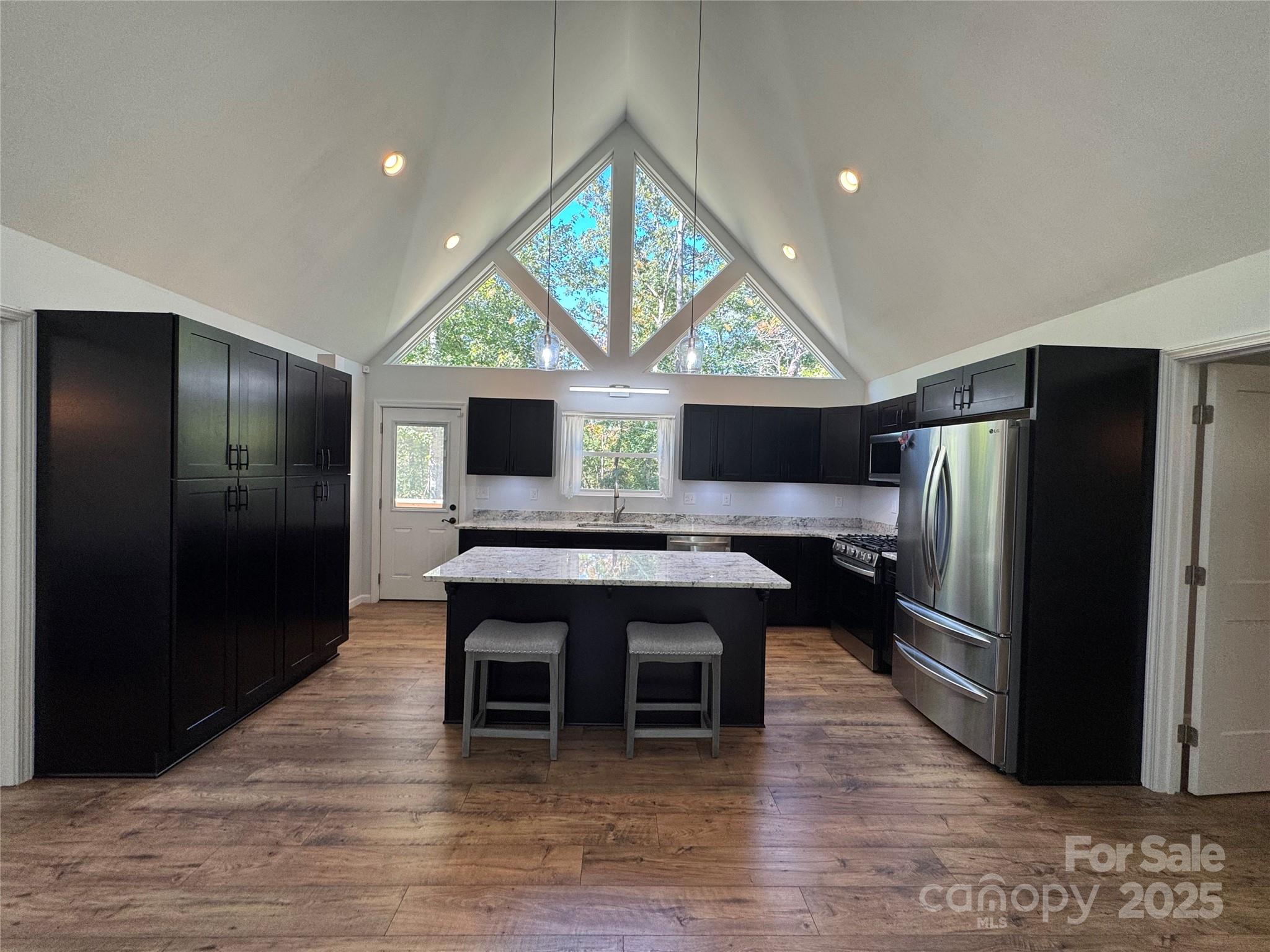 109 Beech Tree Lane Rutherfordton, NC 28139 - Photo 10 of 32 a kitchen with stainless steel appliances granite countertop a table chairs and a refrigerator