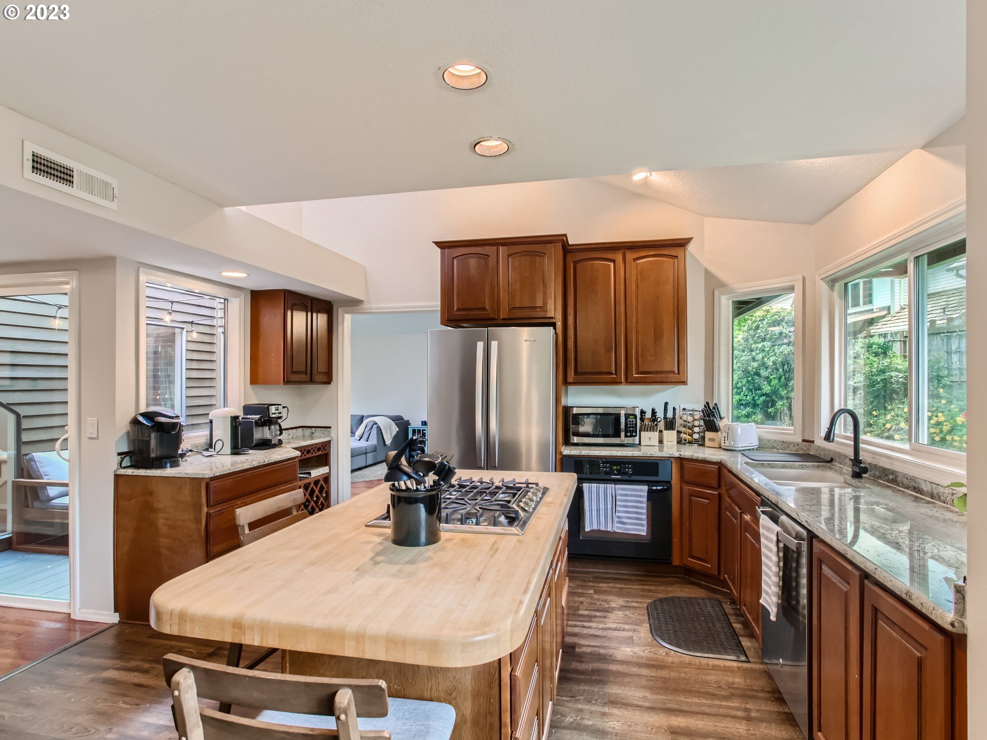 10230 Southwest Kickapoo Court Tualatin, OR 97062 - Photo 11 of 26 a kitchen with stainless steel appliances wooden cabinets dining table and chairs