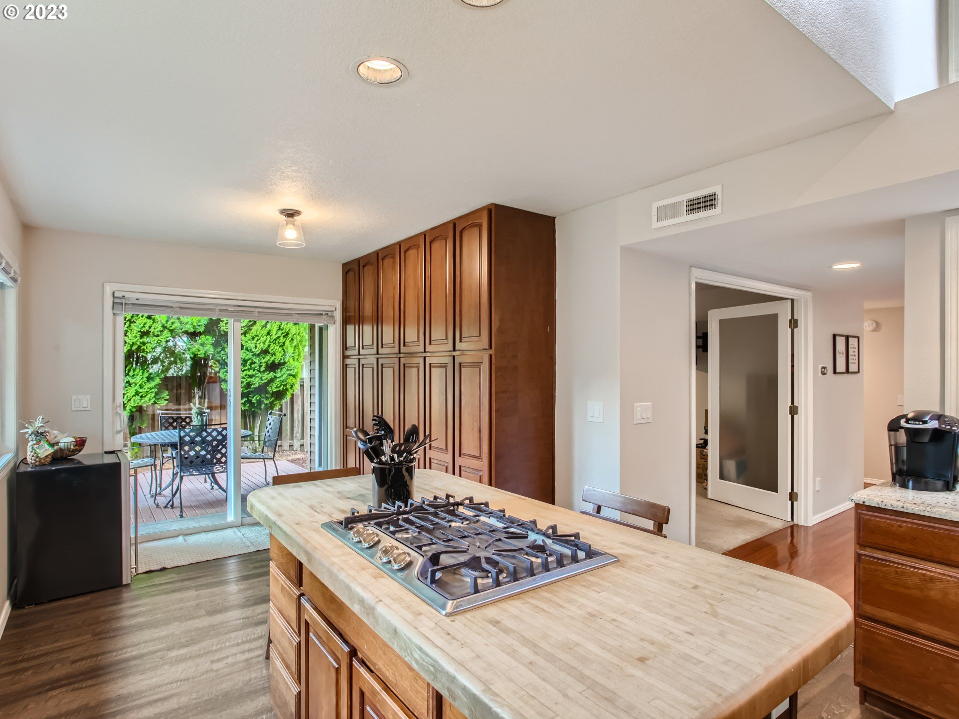 10230 Southwest Kickapoo Court Tualatin, OR 97062 - Photo 12 of 26 a kitchen with stainless steel appliances granite countertop a stove a sink dishwasher and a dining table with garden view