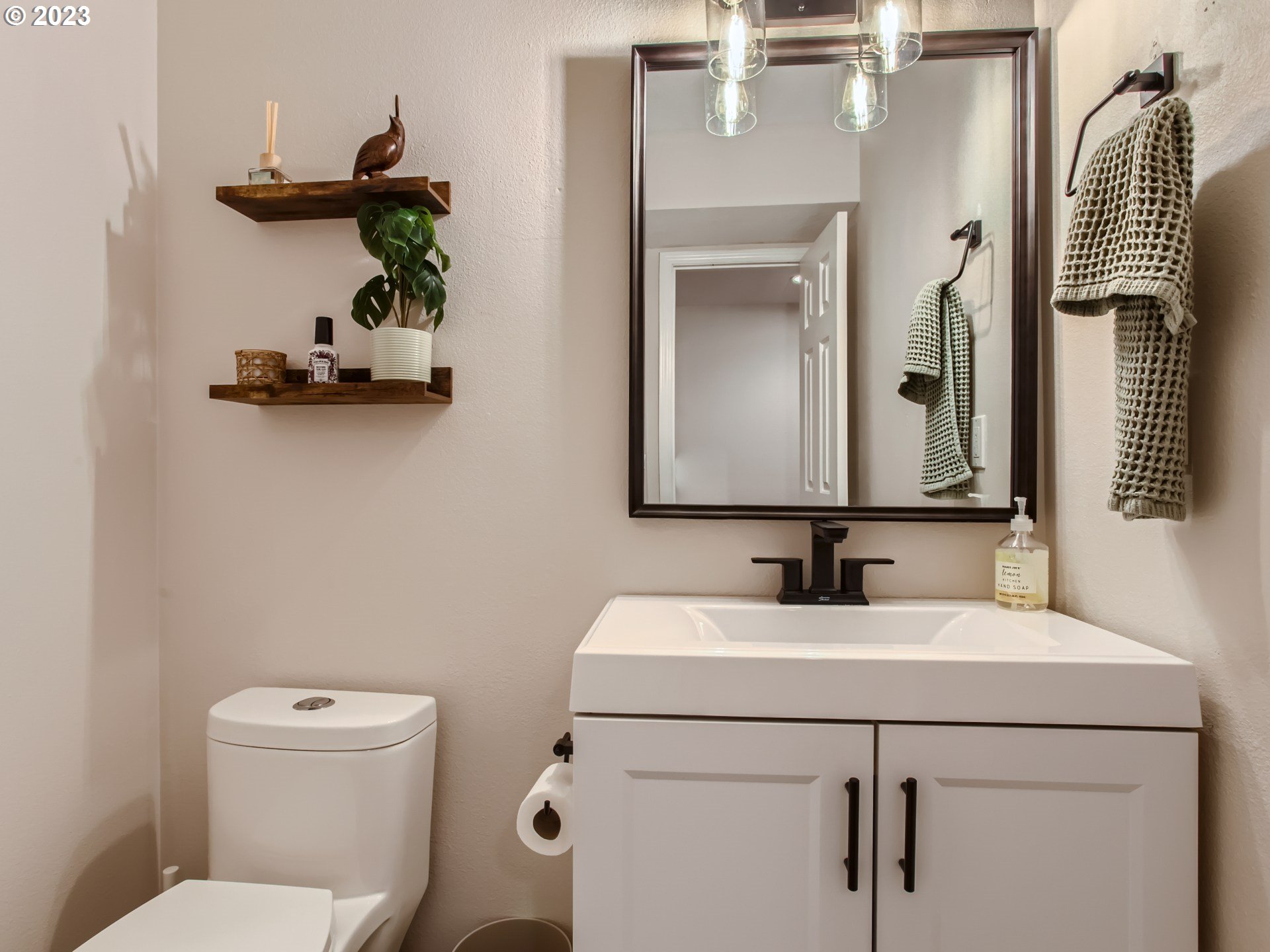 10230 Southwest Kickapoo Court Tualatin, OR 97062 - Photo 14 of 26 a bathroom with a toilet sink and mirror