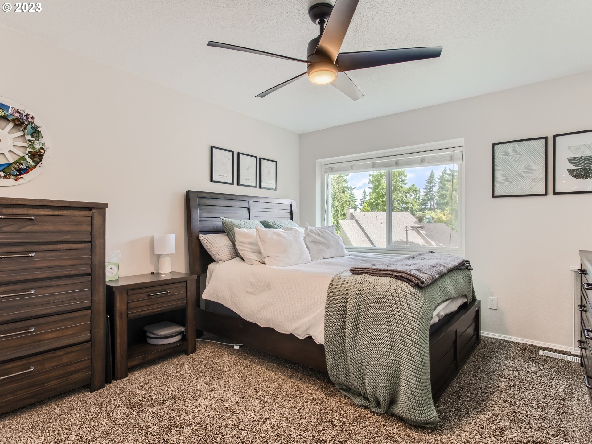 10230 Southwest Kickapoo Court Tualatin, OR 97062 - Photo 19 of 26 a bedroom with a bed and a chandelier